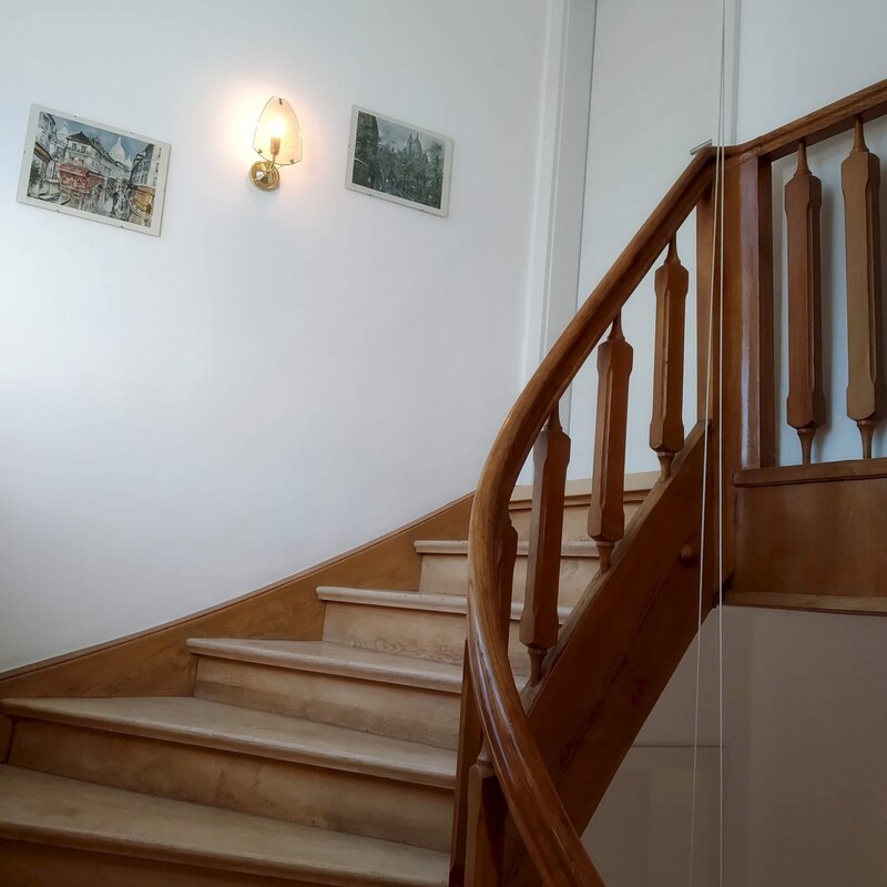 beautiful wooden staircase leads up to the apartment