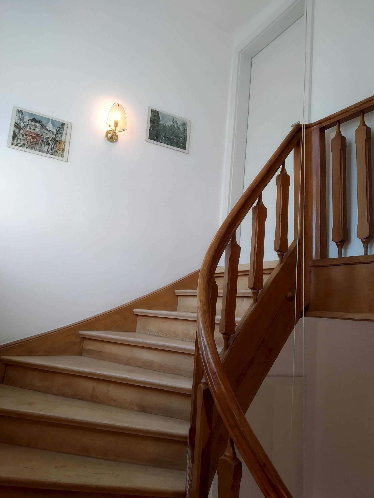 beautiful wooden staircase leads up to the apartment