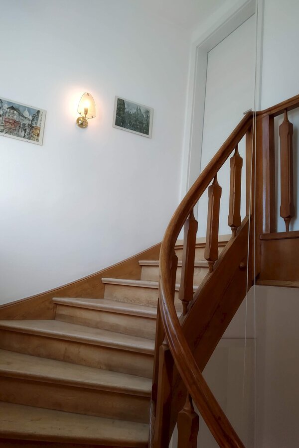 beautiful wooden staircase leads up to the apartment